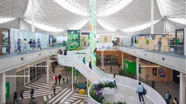 Large spacious foyer in working space with people walking around.